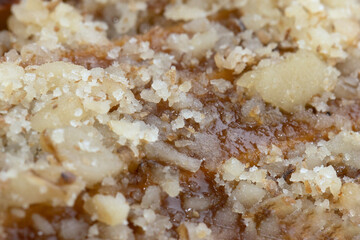 Eclair cake with walnuts and custard filling with nuts, close up.
