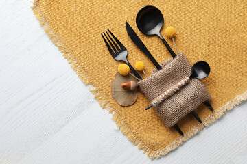 Fototapeta na wymiar Top view of autumn place setting with cutlery on white wooden table, space for text