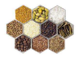 Spices in hexagonal jars isolated on a white background