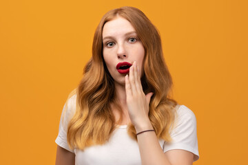 Shocked and surprised girl looking at camera wearing white t-shirt