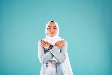 Butterfly hug. A psychology technique for self-soothing from anxiety and anger. A woman cross her arms and tap shoulder.