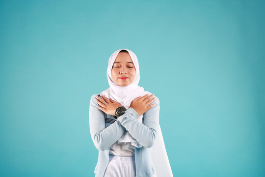 Butterfly hug. A psychology technique for self-soothing from anxiety and anger. A woman cross her arms and tap shoulder.