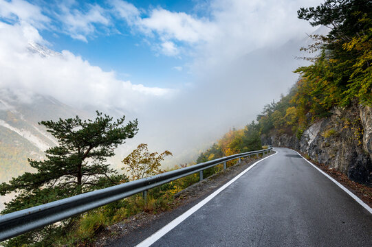 road through autumn forest in Valley Derborence in Valais
