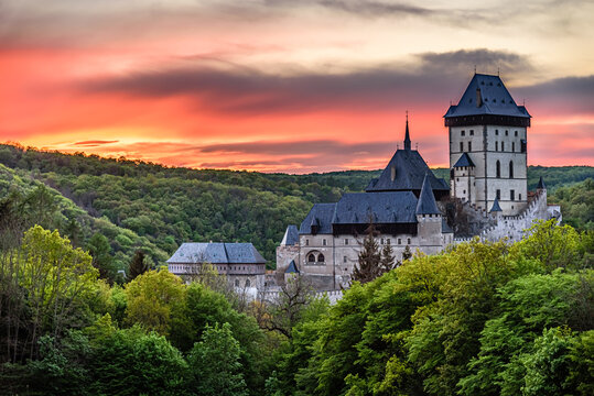 An orange twilight after sunset above the famous castle Karlstejn in Czech republic.