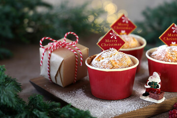 Christmas plain muffins with icing sugar on Christmas decoration background.　クリスマスプレーンマフィン