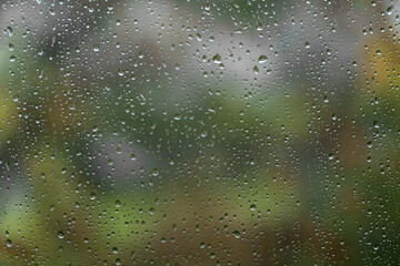Rain drops on window on autumn day