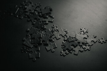 Photo of black puzzles on a black background, business background