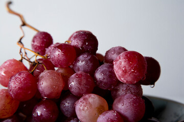 still life of red grapes on white wooden table