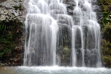 Fototapeta na wymiar Horizontal image of a waterfall in a river