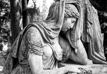 The image of a woman crying in the cemetery. Death of a son