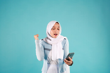portrait of Asian Woman using smartphone on blue background.