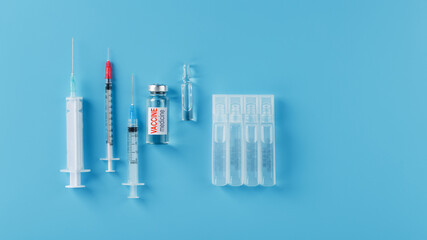 Ampoule of vaccine medicine with a syringe on a blue background.