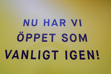 Stockholm, Sweden  A sign at a shopping mall sayin in Swedish "Now we are open again as usual".
