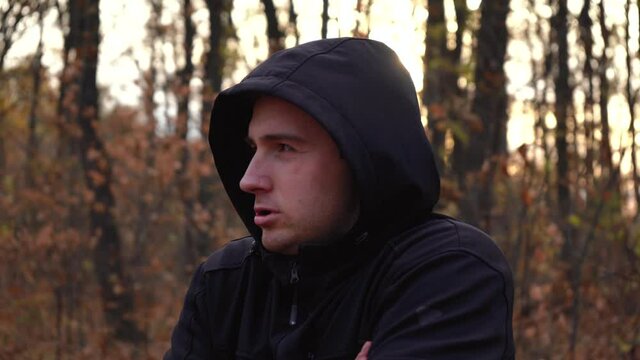 man freezes in the woods in the autumn