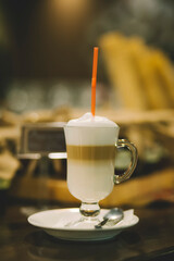 Coffee cocktail with milk in a glass on an old wooden table in a restaurant. glass of fresh coffee cocktail on the table..