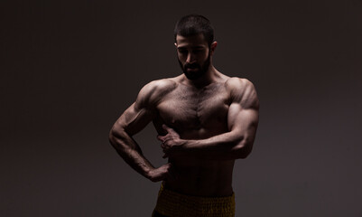 strong athletic man on black background - 388976451