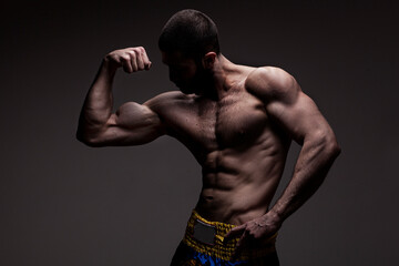 strong athletic man on black background - 388976627