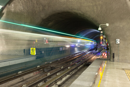 Motion blur of a train coming out of subway tunnel at Metro de Santiago