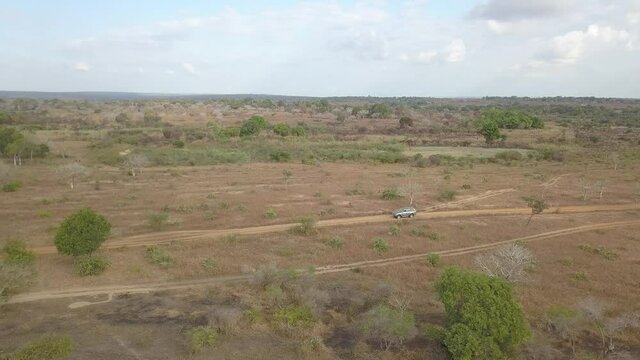 Aerial Shot Of A 4Wd Truck SUV Driving Through Madagascar Countryside