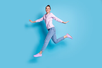 Fototapeta na wymiar Full length body size profile side view of her she nice attractive pretty glad cheerful cheery girl jumping running enjoying free time isolated bright vivid shine vibrant blue color background
