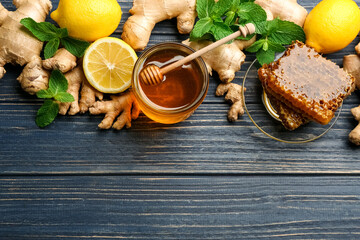 Ginger and other natural cold remedies on blue wooden table, flat lay. Space for text