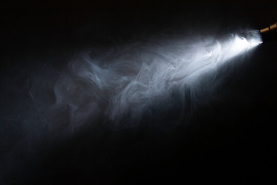 spotlight, ray of light on smoke. black backround
