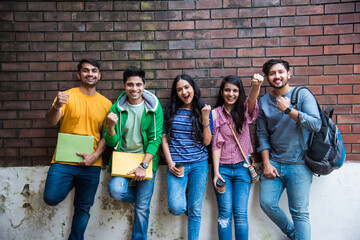Education is fun - Cheerful Indian asian young students enjoying togetherness in college campus