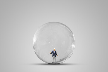 Freedom and Think Outside Box Concept : Businessman standing in the sphere glass on gray background.