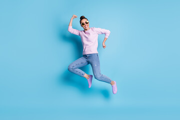 Fototapeta na wymiar Full length photo of positive cheerful girl jump enjoy winter season discounts wear good look pullover footwear specs isolated over blue color background