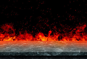 Side view of Empty marble stone table top with orange fire or flame and sparkles in dark room.