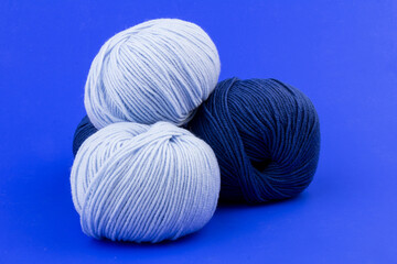 woolen merinos blue threads on blue background. natural wool. knitting. background