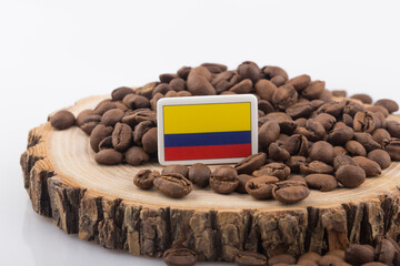 a Colombian flag placed over roasted coffee beans.