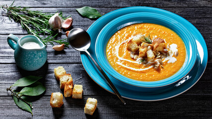 Comforting autumn pumpkin soup in a blue plate