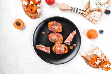 Delicious and healthy dish Grilled peach with prosciutto, capers, microgreen, banner, catering menu recipe place for text, top view