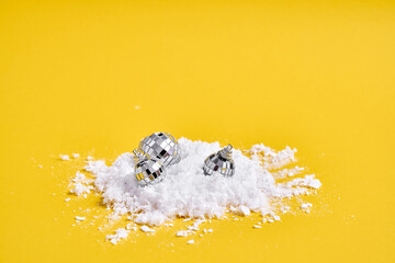 Red white alarm clock with snow on yellow background and podium for product. Creative Christmas sale