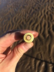 A live 1941 world war 2 machine gun bullet found on a beach in england. World war 2 merobillia, metal detecting on beaches finding buried historical treasures. Weapons and ammunition.