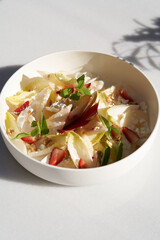 Endive salad with goat cheese, strawberry and walnuts.