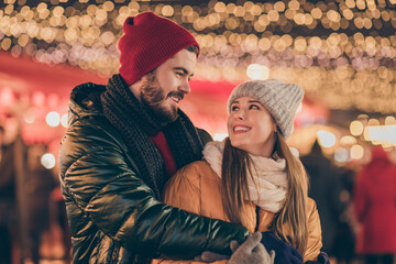 Photo of affectionate bonding couple hug under x-mas christmas newyear lights evening street...