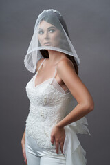 Beautiful young bride in wedding dress with veil