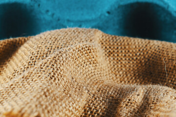 a bag of thread woven into a light blue background