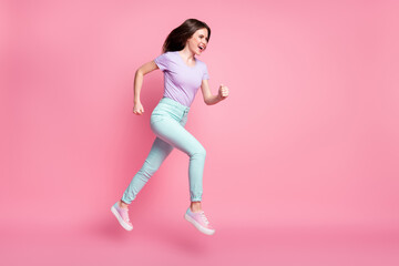 Fototapeta na wymiar Full length profile side photo of crazy girl hear incredible discounts jump run fast copyspace wear violet clothes gumshoes isolated over pink color background