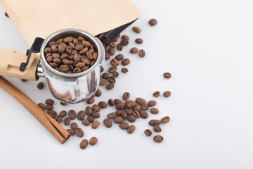 Coffee beans and porta filter with ground coffee.