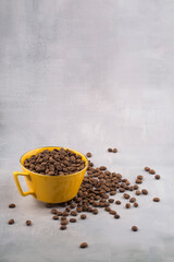 Coffee in yellow cup and coffee beans isolated.