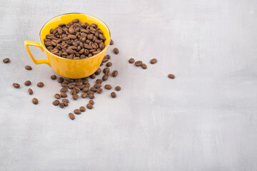 Coffee in yellow cup and coffee beans isolated.