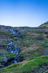 Waterfall free falling from a steep mountain slope. 