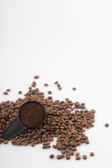 Coffee beans and coffee bean measuring spoon.
