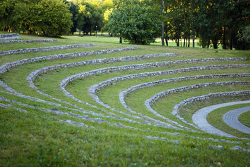 original amphitheater of grass and stones in the park