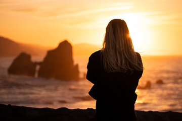 spectacular sunset with a young woman on her back