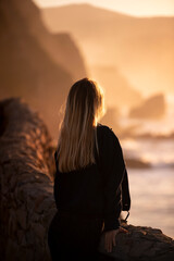 spectacular sunset with a young woman on her back