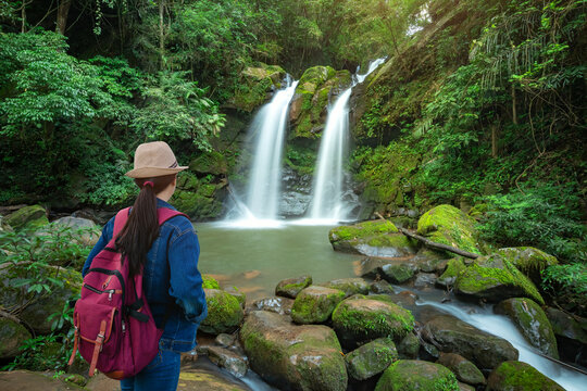 Traveler standing at Sapan Waterfall (Namtok Sapan) 3nd floor is most beautiful waterfall of NAN province. Khun Nan National Park, Sapan village, Boklua District, Nan Province, Thailand